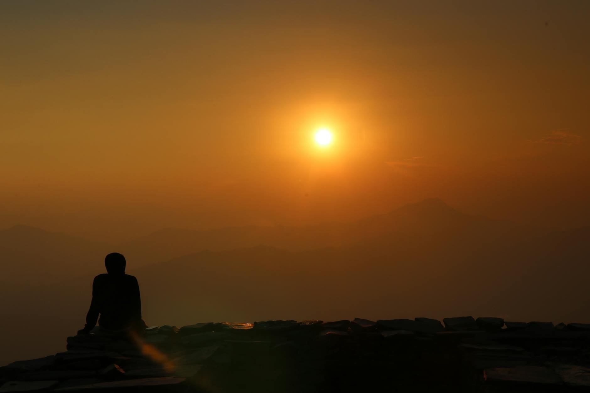 person peacefully meditating outdoors at sunrise, serene expression - metabolic health