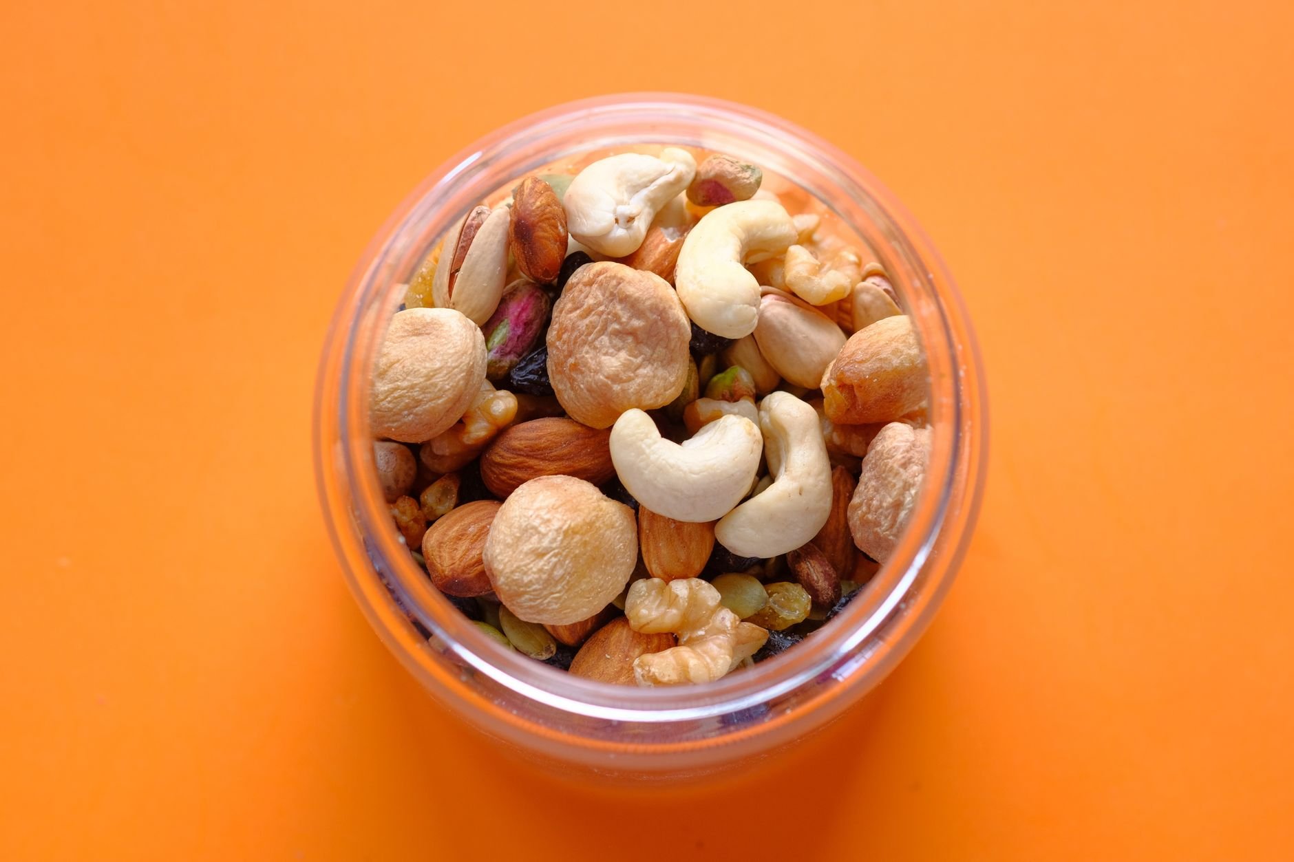 Assortment of magnesium-rich foods (avocado, spinach, almonds) next to a magnesium supplement bottle - Magnesium Deficiency Signs