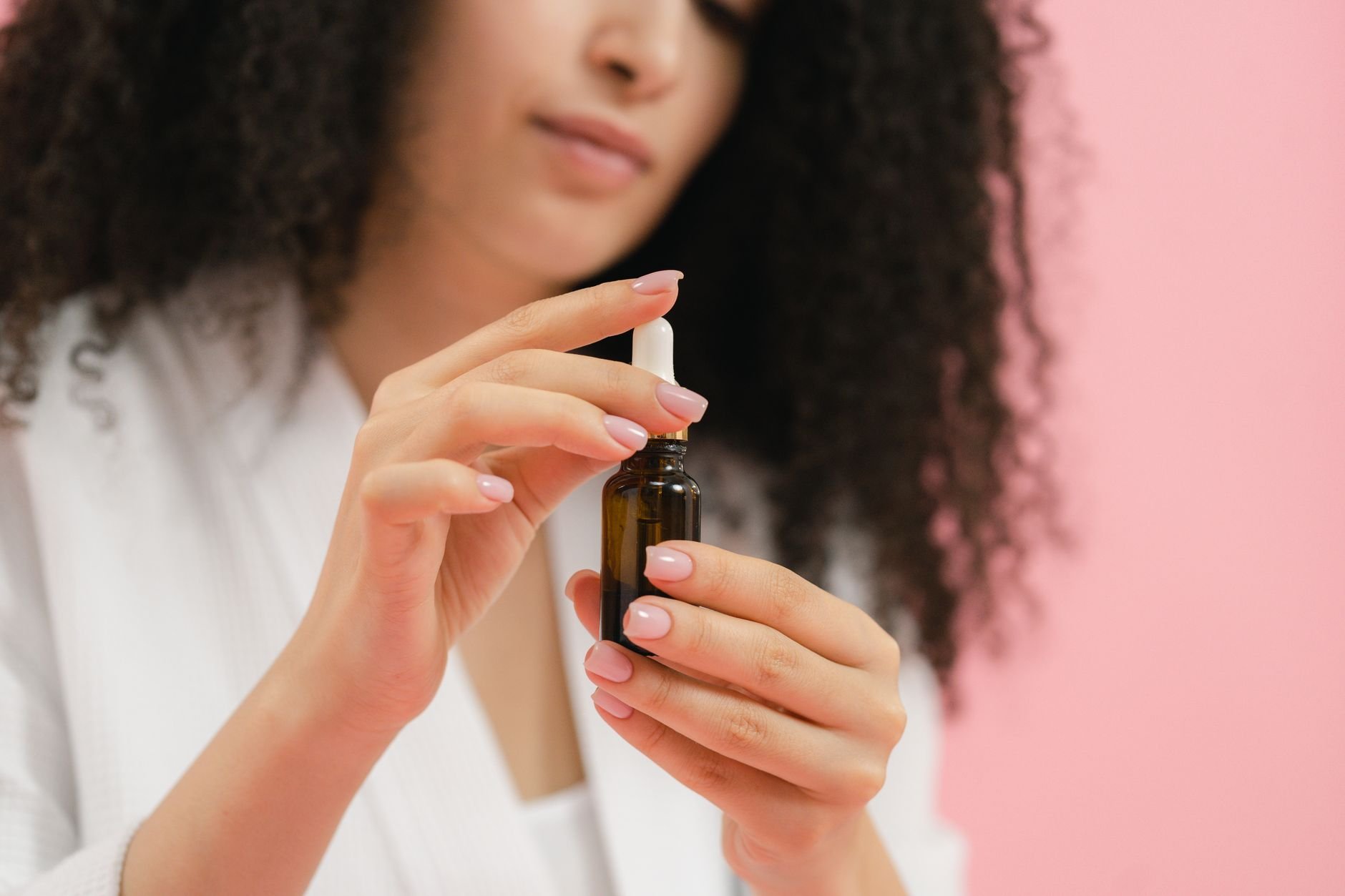 close-up of a person's hands holding a magnesium oil spray bottle - Magnesium for Sleep