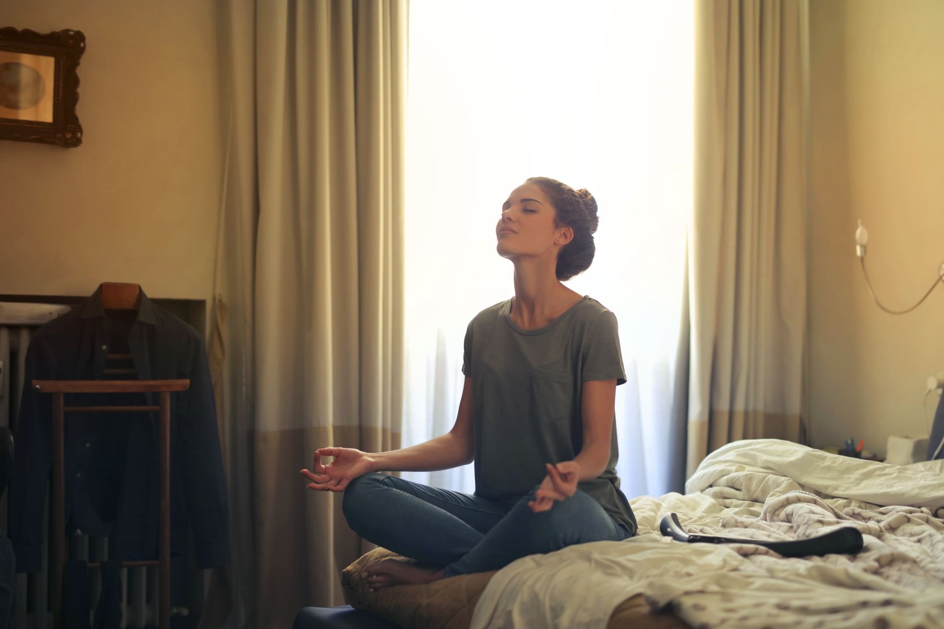 Person in peaceful meditation pose, gentle light, indoor setting - Magnesium Deficiency Signs