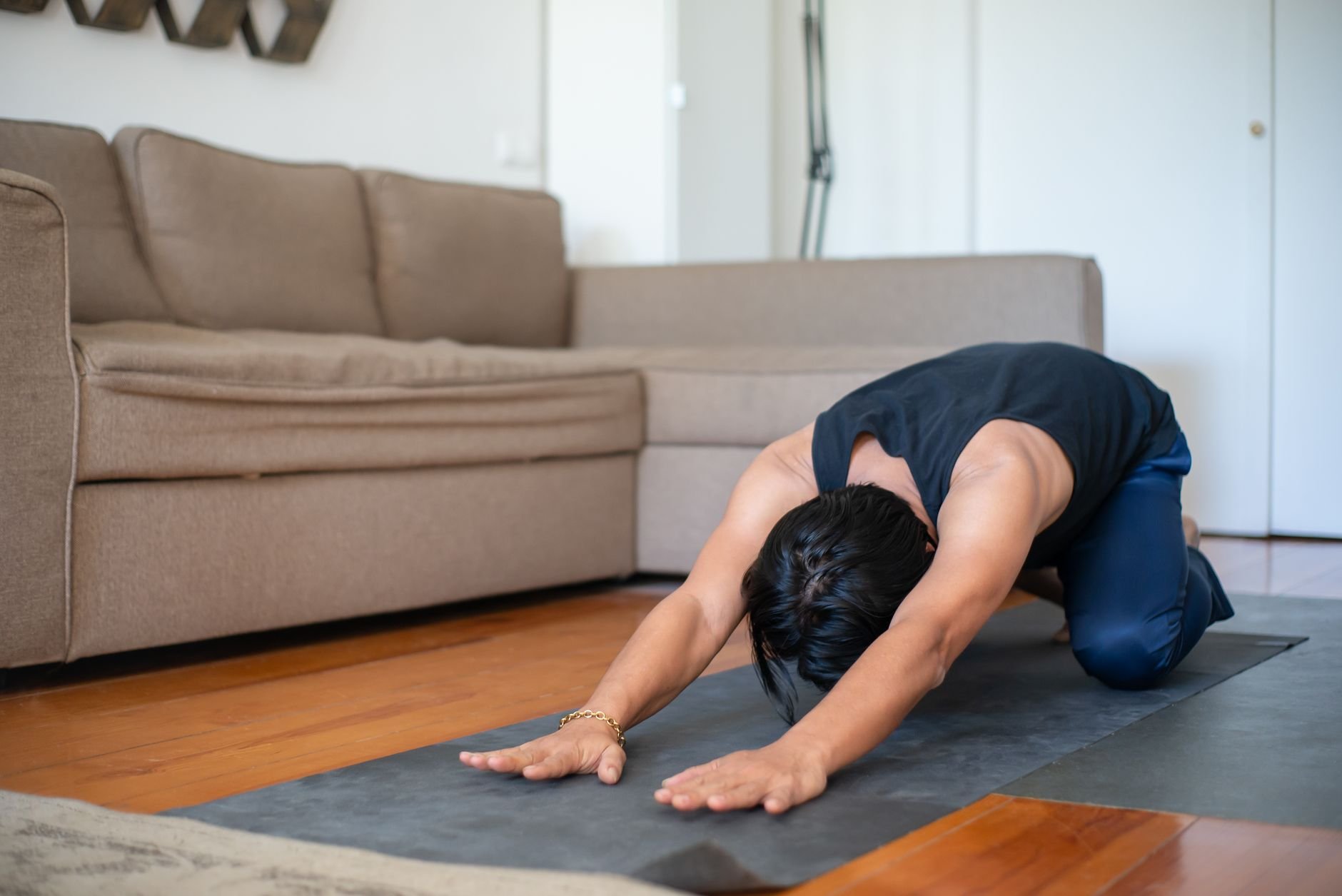 Person performing gentle, pre-sleep yoga stretches in soft lighting - Magnesium for sleep