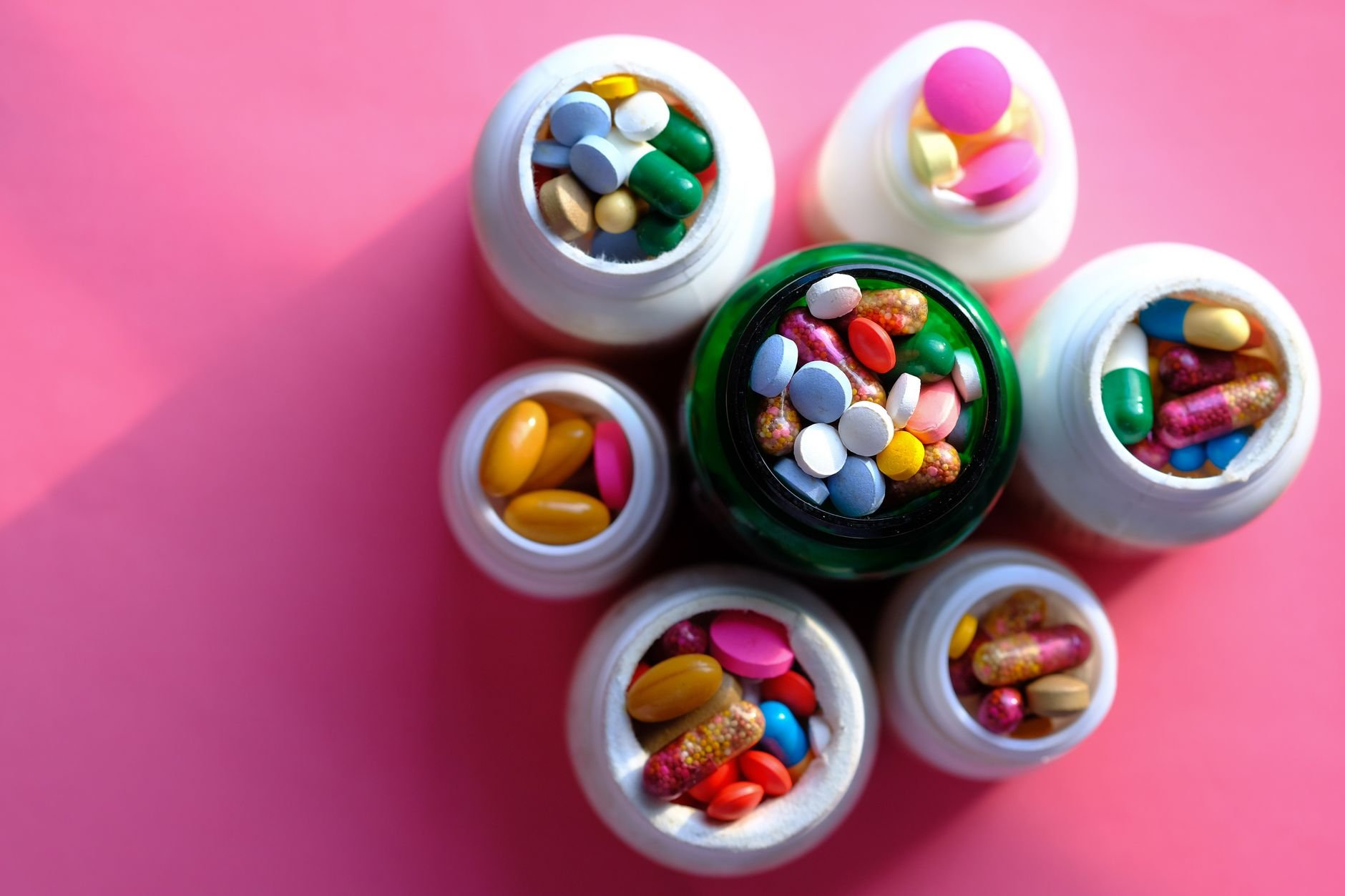 Variety of magnesium supplement bottles arranged neatly on a white background - Magnesium for sleep